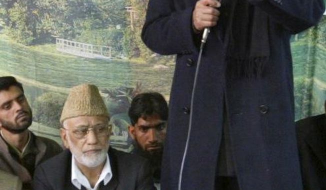 Mohammed Ashraf Sehrai, sitting wearing cap, listens as separatist leader Syed Ali Shah Geelani, standing, addresses a demonstration against the government in Srinagar, India, April 16, 2008. Sehrai, a prominent politician in Kashmir who challenged India’s rule over the disputed region for decades died Wednesday while in police custody. He was 78. (AP Photo /Mukhtar Khan)