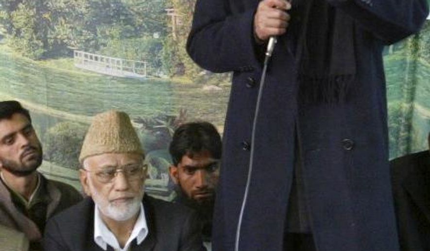 Mohammed Ashraf Sehrai, sitting wearing cap, listens as separatist leader Syed Ali Shah Geelani, standing, addresses a demonstration against the government in Srinagar, India, April 16, 2008. Sehrai, a prominent politician in Kashmir who challenged India’s rule over the disputed region for decades died Wednesday while in police custody. He was 78. (AP Photo /Mukhtar Khan)
