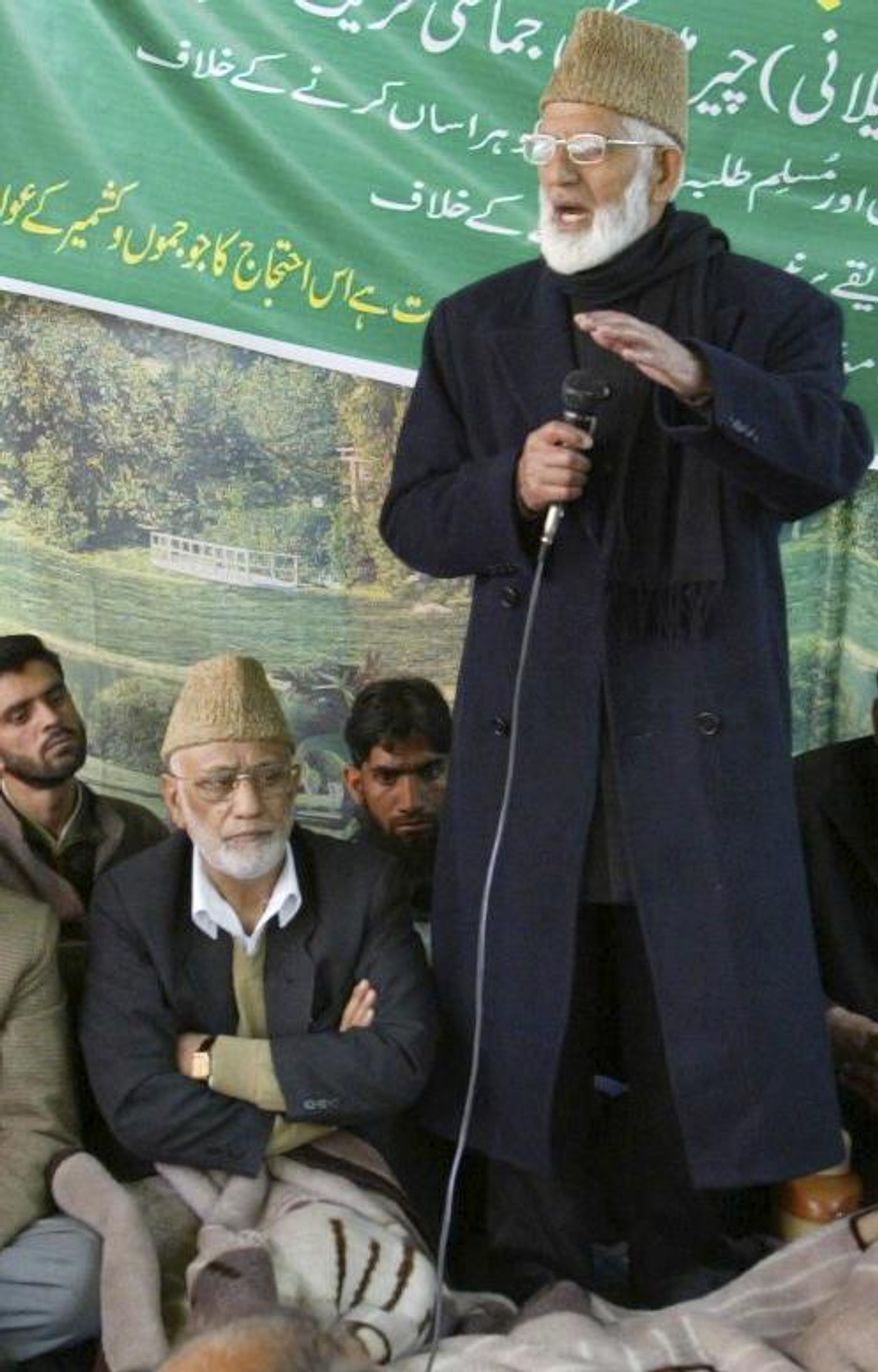 Mohammed Ashraf Sehrai, sitting wearing cap, listens as separatist leader Syed Ali Shah Geelani, standing, addresses a demonstration against the government in Srinagar, India, April 16, 2008. Sehrai, a prominent politician in Kashmir who challenged India’s rule over the disputed region for decades died Wednesday while in police custody. He was 78. (AP Photo /Mukhtar Khan)