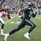 FILE - Seattle Seahawks wide receiver DK Metcalf, right, runs to score a touchdown ahead of Tampa Bay Buccaneers defensive back Jamel Dean during the second half of an NFL football game in Seattle, in this Sunday, Nov. 3, 2019, file photo.  Seahawks wide receiver DK Metcalf is explosive off the line of scrimmage. But Sunday, May 9, 2021, he will venture into a new sort of lane to test his speed on a different sort of line, one that&#39;s filled with Olympic-caliber sprinters. (AP Photo/Scott Eklund, File)