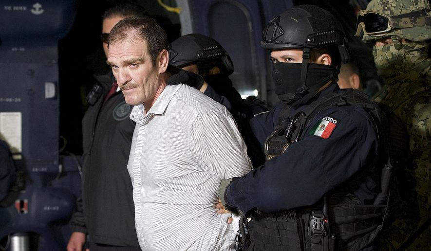 FILE - In this June 15, 2016 file photo provided by the Mexican Attorney General&#x27;s Office, Hector &amp;quot;El Guero&amp;quot; Palma, or “Blondie,” one of the founders of the Sinaloa Cartel, is escorted in handcuffs from a helicopter at a federal hangar in Mexico City, after serving almost a decade in a U.S. prison and transported to another maximum-security lockup to await trial for two murders. (Mexico&#x27;s Attorney General&#x27;s Office via AP, File)