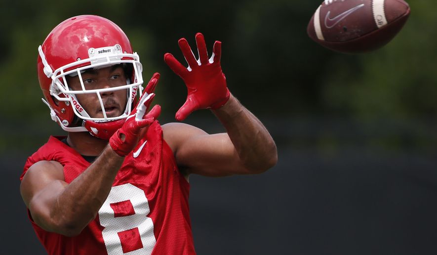 FILE - Georgia wide receiver Dominick Blaylock (8) looks to make a catch during an NCAA football preseason practice in Athens, Ga., in this Friday, Aug. 2, 2019, file photo. The NCAA football oversight committee is preparing to recommend changes to preseason camp that will include fewer fully padded practices and the elimination of some old-school collision drills. The football oversight committee 's initial proposal called for at least nine of a team's 25 preseason practices to be run with players wearing helmets but no other pads, and no more than eight fully-padded, full-contact practices. (Joshua L. Jones/Athens Banner-Herald via AP, File)/