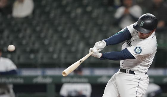 Seattle Mariners&#39; Kyle Seager hits a sacrifice fly to score Sam Haggerty in the eighth inning of a baseball game against the Baltimore Orioles, Tuesday, May 4, 2021, in Seattle. (AP Photo/Ted S. Warren)