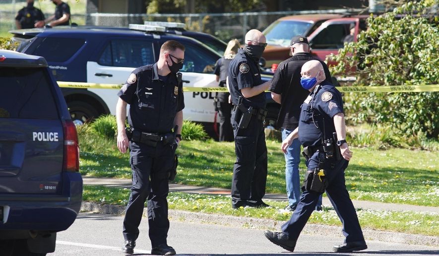 FILE - In this Friday, April 16, 2021, file photo, law enforcement personnel work at the scene following a police-involved shooting of a man at Lents Park, in Portland, Ore. Police fatally shot a man in the city park Friday, April 30, 2021 after responding to reports of a person with a gun. Unlike shootings involving police around the country there was no body camera footage of this encounter. Portland, which has become the epicenter of racial justice protests, is one of the few major U.S. cities where police do not have body cameras. (Beth Nakamura/The Oregonian via AP, File)