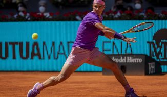 Spain&#39;s Rafael Nadal returns the ball to Spain&#39;s Carlos Alcaraz during their match at the Mutua Madrid Open tennis tournament in Madrid, Spain, Wednesday, May 5, 2021. (AP Photo/Bernat Armangue)