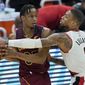 Portland Trail Blazers&#39; Damian Lillard (0) defends against Cleveland Cavaliers&#39; Isaac Okoro during the second half of an NBA basketball game Wednesday, May 5, 2021, in Cleveland. (AP Photo/Tony Dejak)