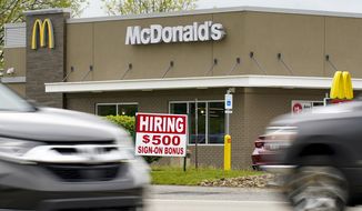 A hiring sign offers a $500 bonus outside a McDonald&#39;s restaurant, in Cranberry Township, Butler County, Pa., Wednesday, May 5, 2021. (AP Photo/Keith Srakocic) ** FILE **