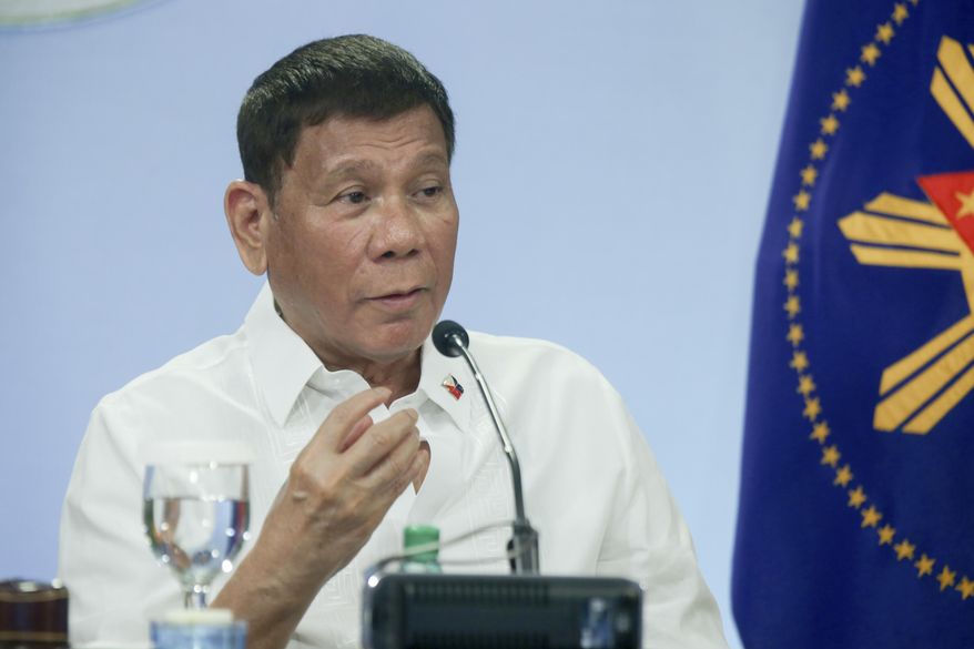 In this photo provided by the Malacanang Presidential Photographers Division, Philippine President Rodrigo Duterte gestures after meeting with the Inter-Agency Task Force on the Emerging Infectious Diseases (IATF-EID) core members at the Malacanang presidential palace in Manila, Philippines Wednesday, May 5, 2021. The Philippine president has asked China to get back 1,000 doses of donated Sinopharm vaccine after facing criticisms for allowing himself to be injected with it although it has not yet been authorized for public use in the country. (Simeon Celi/Malacanang Presidential Photographers Division via AP)