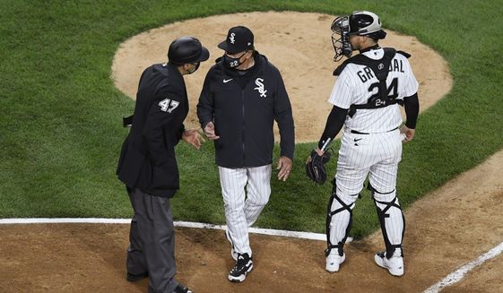 FILE - In this April 12, 2021, file photo, Chicago White Sox manager Tony La Russa, center, argues with home plate umpire Gabe Morales (47) while catcher Yasmani Grandal (24) listens during the ninth inning of the team&#39;s baseball against the Cleveland Indians in Chicago. La Russa developed a reputation as a master strategist while managing the Oakland Athletics to a World Series championship and the St. Louis Cardinals to two more. His second tenure with the Chicago White Sox is off to a bumpy start. (AP Photo/Paul Beaty, File)