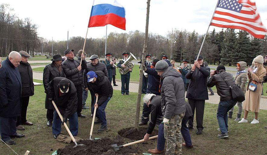 Russians and Americans plant "Friendship" tree in the "Victory Park" on Poklonnaya Gora in Moscow on April 25, 2021.
