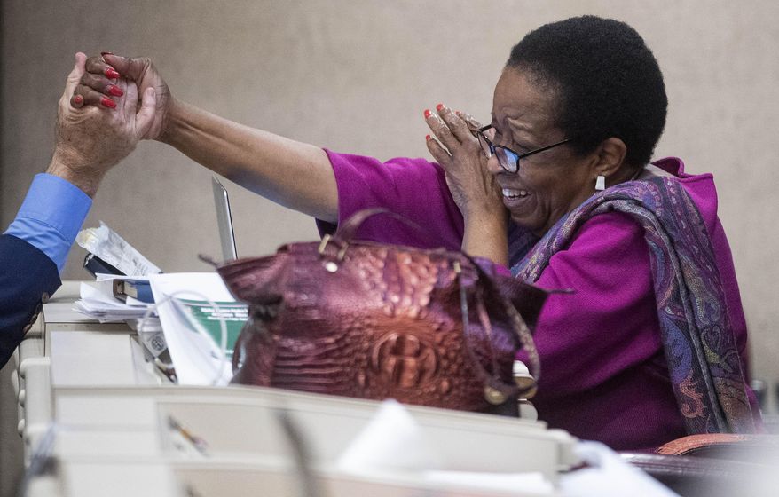 Rep. Laura Hall is congratulated after the Medical Cannabis bill is amended to be named after her son, during debate in the House chamber at the Alabama Statehouse in Montgomery, Ala., on Thursday May 6, 2021. (Mickey Welsh/The Montgomery Advertiser via AP)