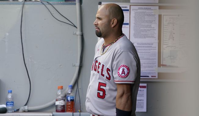 Los Angeles Angels Albert Pujols leans on his bat in the dugout during the eighth inning of a baseball game against the Seattle Mariners, Sunday, May 2, 2021, in Seattle.  (AP Photo/Ted S. Warren) **FILE**