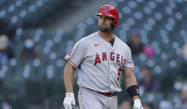 Los Angeles Angels Albert Pujols walks to the dugout after he was called out on strikes during the ninth inning of a baseball game against the Seattle Mariners, Sunday, May 2, 2021, in Seattle.  (AP Photo/Ted S. Warren) **FILE**