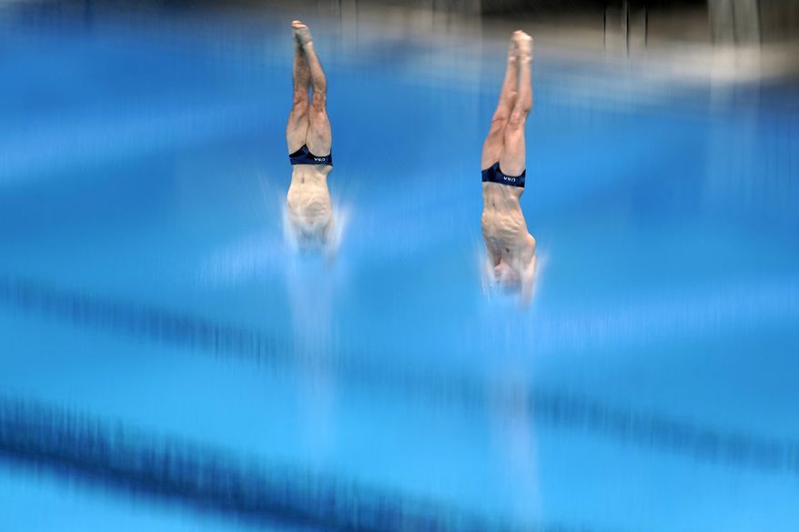 United States' Michael Hixon and Andrew Capobianco perform a dive during the men's synchronized 3-meter springboard preliminaries at the FINA Diving World Cup Sunday, May 2, 2021, at the Tokyo Aquatics Centre in Tokyo. (AP Photo/Eugene Hoshiko)