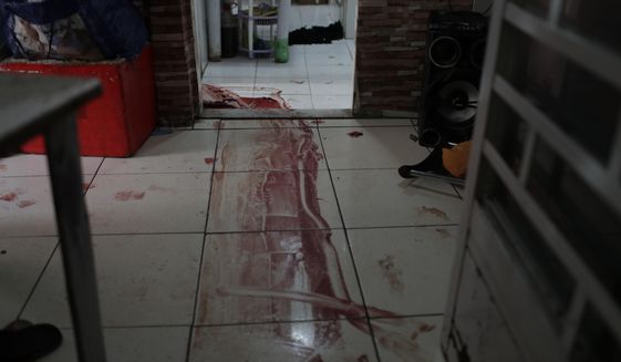 Blood covers the floor of a home during a police operation targeting drug traffickers in the Jacarezinho favela of Rio de Janeiro, Brazil, Thursday, May 6, 2021. At least 25 people died including one police officer and 24 suspects, according to the press office of Rio&#x27;s civil police. (AP Photo/Silvia Izquierdo)