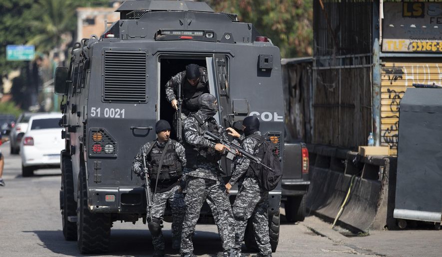 Police get out of an armored vehicle during an operation against alleged drug traffickers in the Jacarezinho favela of Rio de Janeiro, Brazil, Thursday, May 6, 2021. (AP Photo/Silvia Izquierdo)