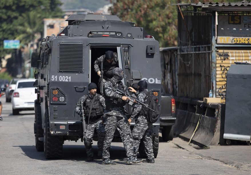 Police get out of an armored vehicle during an operation against alleged drug traffickers in the Jacarezinho favela of Rio de Janeiro, Brazil, Thursday, May 6, 2021. (AP Photo/Silvia Izquierdo)