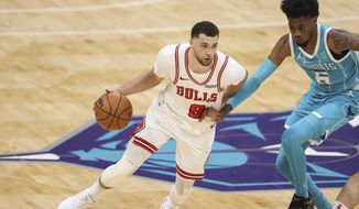 Chicago Bulls guard Zach LaVine, left, drives against Charlotte Hornets forward Jalen McDaniels during the second half of an NBA basketball game in Charlotte, N.C., Thursday, May 6, 2021. (AP Photo/Nell Redmond)