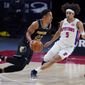 Memphis Grizzlies guard Desmond Bane (22) drives as Detroit Pistons guard Frank Jackson (5) defends during the first half of an NBA basketball game, Thursday, May 6, 2021, in Detroit. (AP Photo/Carlos Osorio)