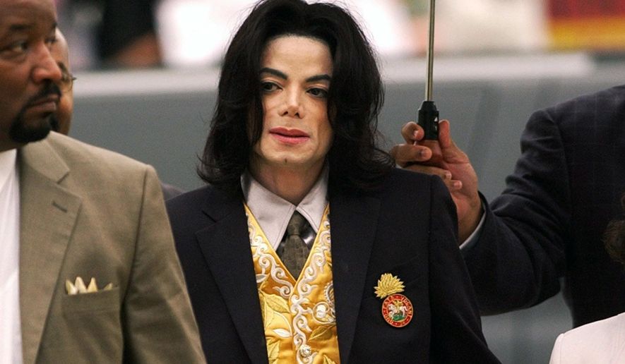 FILE - In this May 25, 2005, file photo, Michael Jackson arrives at the Santa Barbara County Courthouse for his trial in Santa Maria, Calif. On Monday, May 3, 2021, a U.S. tax court handed a major victory to Jackson&#39;s estate in a years-long battle, finding that the IRS inflated the value of Jackson’s assets and image at the time of his 2009 death. (Aaron Lambert/Santa Maria Times via AP, Pool, File)