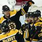 Boston Bruins right wing David Pastrnak (88), defenseman Charlie McAvoy (73), and center Brad Marchand (63) gather to celebrate a goal by center Patrice Bergeron, right, in the first period of an NHL hockey game against the New York Rangers, Thursday, May 6, 2021, in Boston. (AP Photo/Elise Amendola)