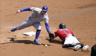 Minnesota Twins&#39; Nick Gordon, right, steals second base as the throws gets past Texas Rangers second baseman Nick Solak in the second inning of a baseball game, Thursday, May 6, 2021, in Minneapolis. (AP Photo/Jim Mone)