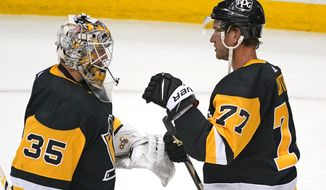 Pittsburgh Penguins center Jeff Carter (77) celebrates with goaltender Tristan Jarry after a win over the Buffalo Sabres in an NHL hockey game in Pittsburgh, Thursday, May 6, 2021. (AP Photo/Gene J. Puskar)