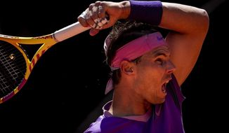 Spain&#39;s Rafael Nadal returns the ball to Australia&#39;s Alexei Popyrin during their match at the Mutua Madrid Open tennis tournament in Madrid, Spain, Thursday, May 6, 2021. (AP Photo/Bernat Armangue)