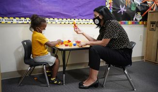 Teacher Juliana Urtubey, right, interacts with Kamari Wolfe in a class at Kermit R Booker Sr Elementary School Wednesday, May 5, 2021, in Las Vegas. Urtubey is the the 2021 National Teacher of the Year. (AP Photo/John Locher)