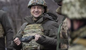 In this Thursday, Feb. 11, 2021, file photo, Ukrainian President Volodymyr Zelensky talks with servicemen as he visits the war-hit Donetsk region, eastern Ukraine. On the frontlines of the battle against Russia-backed separatists and in the halls of government in Kyiv, Ukrainians hold strong hopes for the visit of the U.S. Secretary of State — increased military aid and strong support for NATO membership among them. (Ukrainian Presidential Press Office via AP, File)