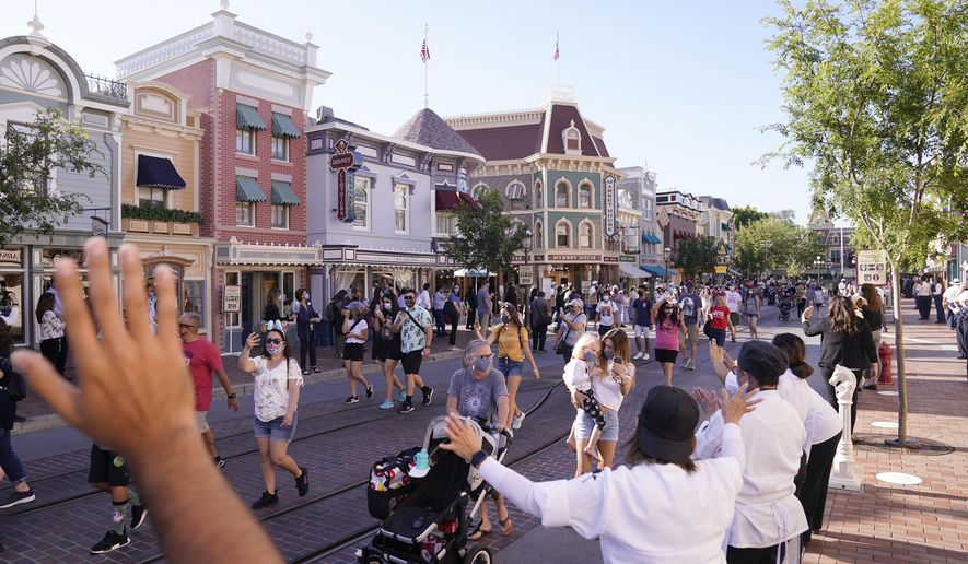 In this April 30, 2021, photo, guests walk down Main Street USA at Disneyland in Anaheim, Calif. (AP Photo/Jae Hong) **FILE**