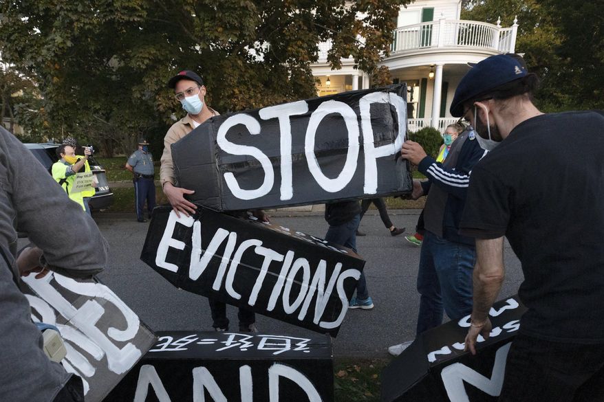 FILE - In this Oct. 14, 2020, file photo, housing activists erect a sign in front of Massachusetts Gov. Charlie Baker's house in Swampscott, Mass. A federal judge has ruled, Wednesday, May 5, 2021, that the Centers for Disease Control exceeded its authority when it imposed a federal eviction moratorium to provide protection for renters out of concern that having families lose their homes and move into shelters or share crowded conditions with relatives or friends during the pandemic would further spread the highly contagious virus. (AP Photo/Michael Dwyer, File)
