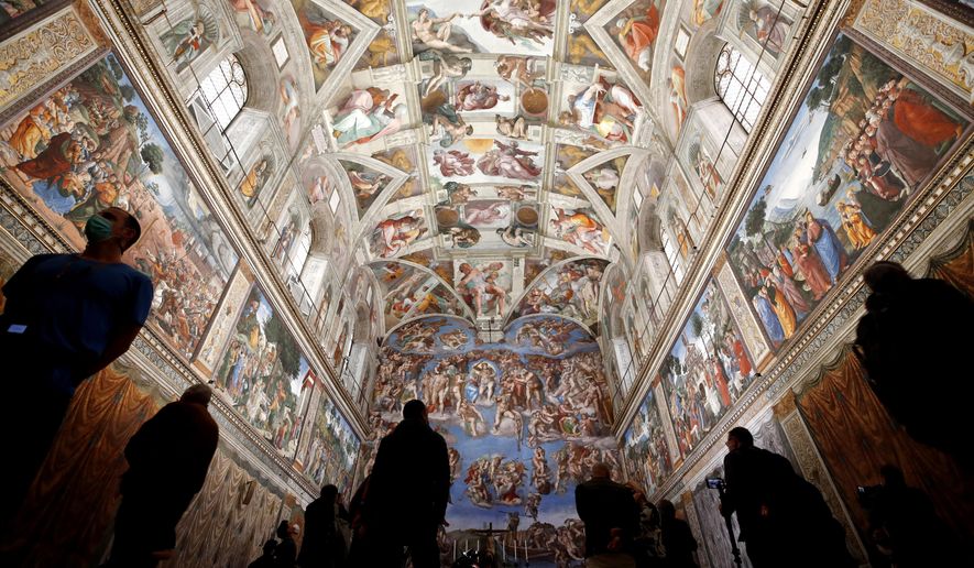 Visitors admire the Sistine Chapel inside the Vatican Museums on the occasion of the museum&#x27;s reopening, in Rome, Monday, May 3, 2021. The Vatican Museums reopened Monday to visitors after a shutdown following COVID-19 containment measures. (AP Photo/Alessandra Tarantino)