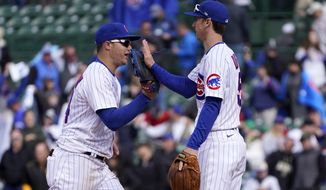Chicago Cubs&#39; Joc Pederson, left, and Matt Duffy celebrate their win over the Pittsburgh Pirates after a baseball game Friday, May 7, 2021, in Chicago. (AP Photo/Charles Rex Arbogast)