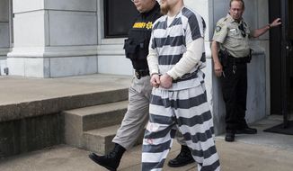 FILE - In this Oct. 27, 2016, file photo, Jacob Ewing, is led out of the Jackson County Courthouse in Holton, Kan. Ewing has accepted a plea agreement expected to bring him 10 years in prison for two sexual assaults that divided his small northeast Kansas town. Ewing, of Holton,  pleaded guilty Friday, May 7, 2021, to two counts of aggravated sexual battery. (Emily Deshazer/The Topeka Capital-Journal via AP, File)