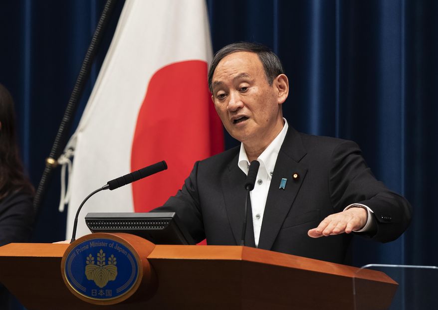 Japanese Prime Minister Yoshihide Suga responds to a reporter&#39;s question after he spoke at a news conference in Tokyo on Friday, May 7, 2021. Suga announced an extension of a state of emergency in Tokyo and other areas through May 31. (AP Photo/Hiro Komae)