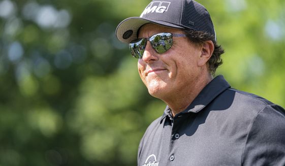 Phil Mickelson smiles to the crowd after the third hole during the first round of the Wells Fargo Championship golf tournament at Quail Hollow on Thursday, May 6, 2021, in Charlotte, N.C. (AP Photo/Jacob Kupferman)