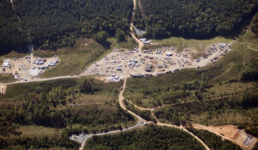 In this Sept. 20, 2016, file photo, vehicles are seen near Colonial Pipeline in Helena, Ala. A major pipeline that transports fuels along the East Coast says it had to stop operations because it was the victim of a cyberattack. Colonial Pipeline said in a statement late Friday that it took certain systems offline to contain the threat, which has temporarily halted all pipeline operations and affected some of its IT systems. (AP Photo/Brynn Anderson, File)