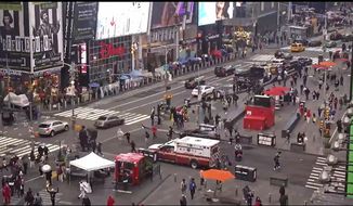 In this image taken from video by the FDNY, pedestrians hurry away from the scene of a shooting in Times Square, Saturday, May 8, 2021, in New York. New York City police say three innocent bystanders including a 4-year-old girl who was toy shopping have been shot in Times Square and officers are looking for suspects. All the victims are expected to recover. (FDNY via AP)