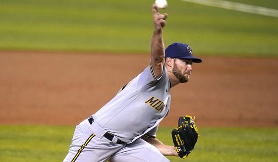 Milwaukee Brewers starting pitcher Adrian Houser throws during the first inning of a baseball game against the Miami Marlins, Saturday, May 8, 2021, in Miami. (AP Photo/Lynne Sladky)