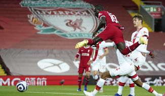 Liverpool&#x27;s Sadio Mane, front, scores his side&#x27;s opening goal during the English Premier League soccer match between Liverpool and Southampton at Anfield stadium in Liverpool, England, Saturday, May 8, 2021. (Zac Goodwin/Pool via AP)