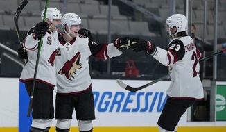 Arizona Coyotes defenseman Victor Soderstrom, center, celebrates with Jan Jenik, left, and Oliver Ekman-Larsson (23) after scoring a goal against the San Jose Sharks during the second period of an NHL hockey game Friday, May 7, 2021, in San Jose, Calif. (AP Photo/Tony Avelar)