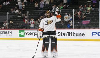 Anaheim Ducks goalie Ryan Miller waves to the crowd during a standing ovation after it was announced that this would be his last NHL hockey game, against the Minnesota Wild on Saturday, May 8, 2021, in St. Paul, Minn. (AP Photo/Craig Lassig)
