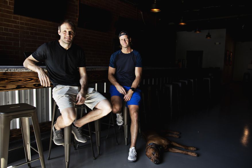 This Friday, April 30, 2021 photo shows from left, Bates and Anthony Battaglia in Raleigh, N.C. The brothers are opening a new Glenwood South sports bar, Teets, named after their grandfather. (Juli Leonard/The News & Observer via AP)