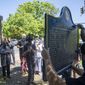 People gather to watch the installation of a historical marker that tells the story of the lynching of Porter Flournoy Turner in Atlanta&#x27;s Druid Hills community, Thursday, May 6, 2021. Porter Turner was lynched near the area in August 1945. (Alyssa Pointer/Atlanta Journal-Constitution via AP)