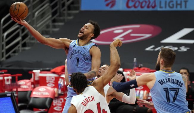 Memphis Grizzlies forward Kyle Anderson (1) puts up a shot over Toronto Raptors center Khem Birch (24) during the first half of an NBA basketball game Saturday, May 8, 2021, in Tampa, Fla. (AP Photo/Chris O&#x27;Meara)