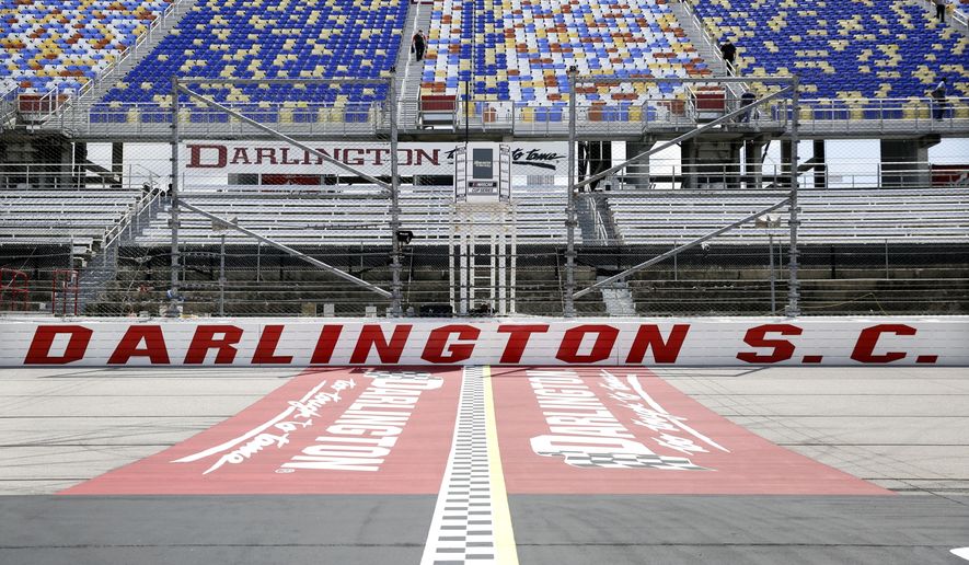 FILE - In this May 17, 2020, file photo, the grandstands are empty at Darlington Raceway before a NASCAR Cup Series auto race in Darlington, S.C. Darlington Raceway officials are excited about hosting the first of two scheduled NASCAR weekends, something the track hadn’t featured since 2004. (AP Photo/Brynn Anderson, File)
