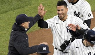 New York Yankees&#39; Gleyber Torres is congratulated by manager Aaron Boone after Torres drove in the winning run in the 11th inning of the team&#39;s baseball game against the Washington Nationals on Saturday, May 8, 2021, at Yankee Stadium in New York. The Yankees won 4-3. (AP Photo/Bill Kostroun)