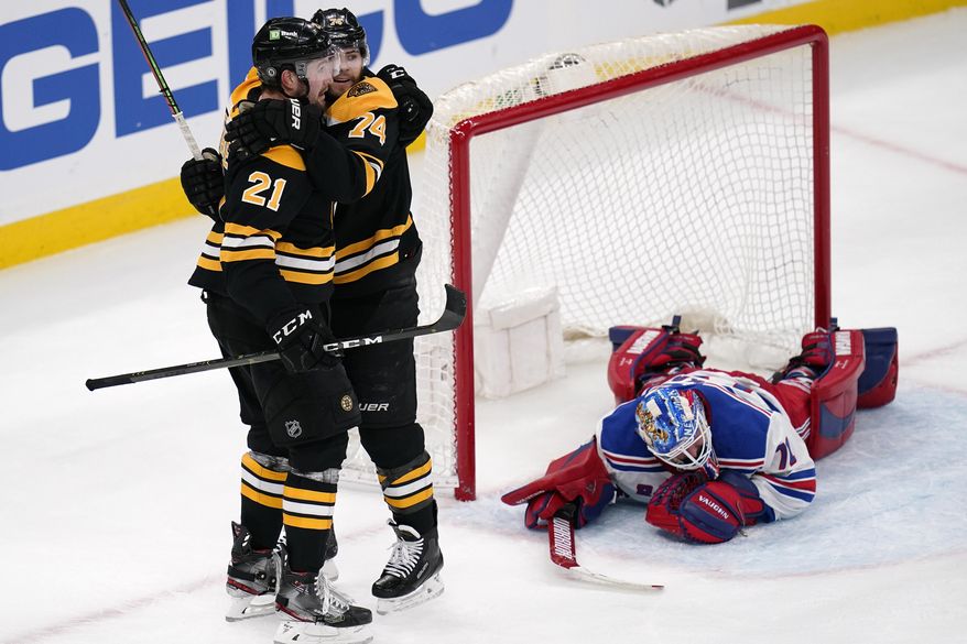 Boston Bruins left wing Nick Ritchie (21) is congratulated by Jake DeBrusk after his goal against New York Rangers goaltender Keith Kinkaid during the second period of an NHL hockey game, Saturday, May 8, 2021, in Boston. (AP Photo/Charles Krupa)