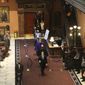 South Carolina senators walk across the Statehouse lobby for a joint session with the House on Wednesday, May 5, 2021, in Columbia, S.C. Senators sat in the balcony for the joint session because of COVID-19 concerns. (AP Photo/Jeffrey Collins)